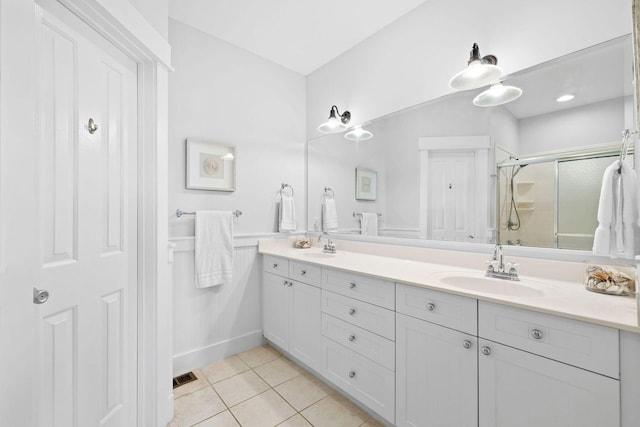 bathroom featuring vanity, an enclosed shower, and tile patterned flooring