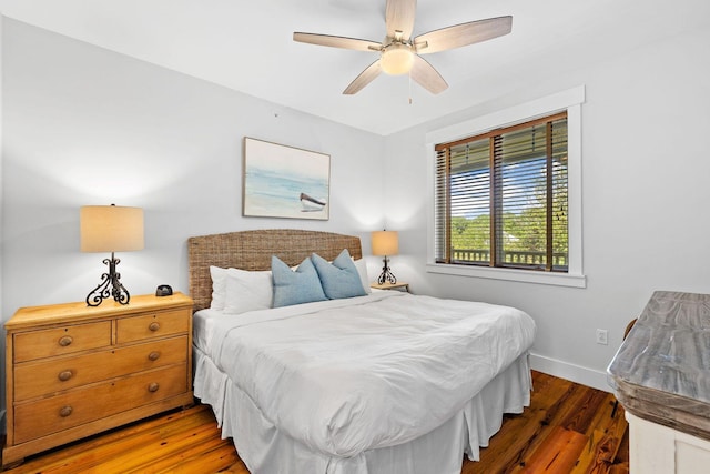 bedroom featuring ceiling fan and dark hardwood / wood-style floors