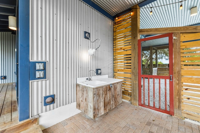 bathroom featuring wood walls and sink