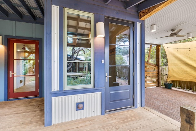 view of exterior entry featuring ceiling fan