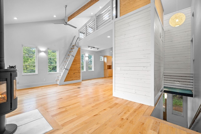 living room featuring hardwood / wood-style flooring, beamed ceiling, high vaulted ceiling, and a wealth of natural light