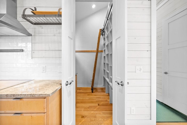 kitchen with hardwood / wood-style floors and light brown cabinets