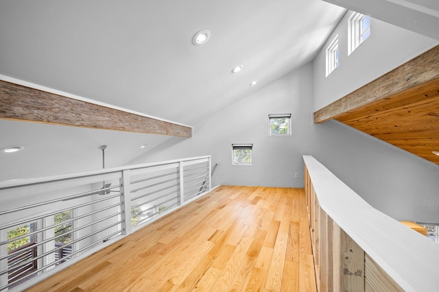 interior space with a healthy amount of sunlight, high vaulted ceiling, and hardwood / wood-style flooring