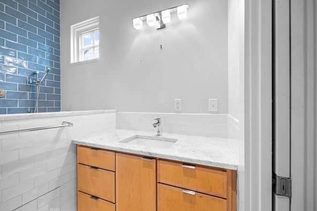 bathroom with vanity and tile walls