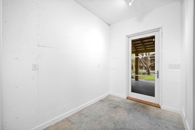 doorway to outside featuring concrete floors