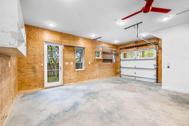 garage with wood walls and ceiling fan