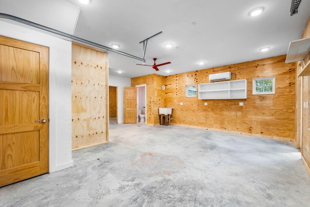 unfurnished room featuring ceiling fan, an AC wall unit, and wooden walls