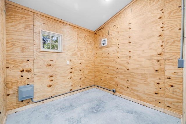 unfurnished room with concrete flooring and vaulted ceiling