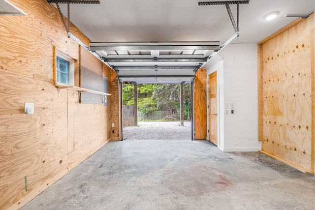 garage featuring wooden walls