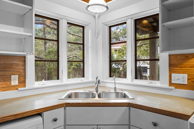 kitchen with plenty of natural light, washer / dryer, and sink