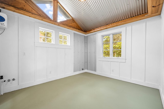 empty room featuring concrete floors and lofted ceiling with skylight