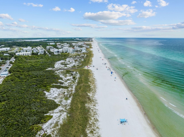 birds eye view of property with a water view and a beach view