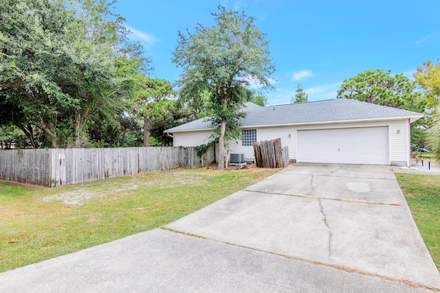 ranch-style home with cooling unit, a front lawn, and a garage