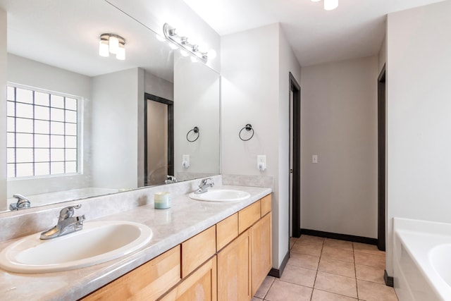 bathroom featuring vanity, tile patterned flooring, and a bathtub