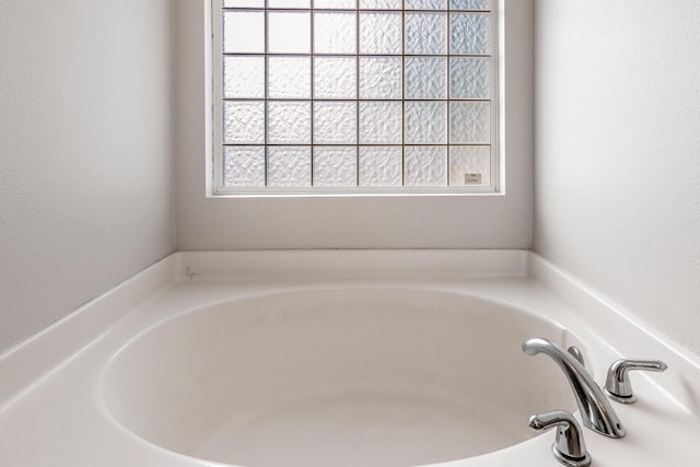 interior space with a tub and plenty of natural light