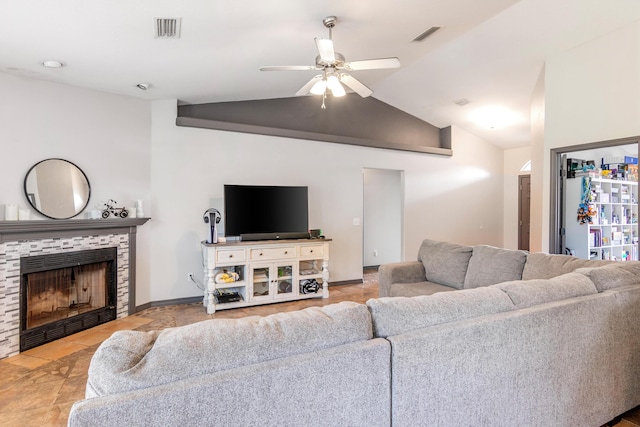 living room with lofted ceiling, light tile patterned floors, ceiling fan, and a tile fireplace