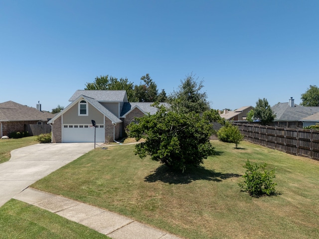 view of front of property with a garage and a front lawn