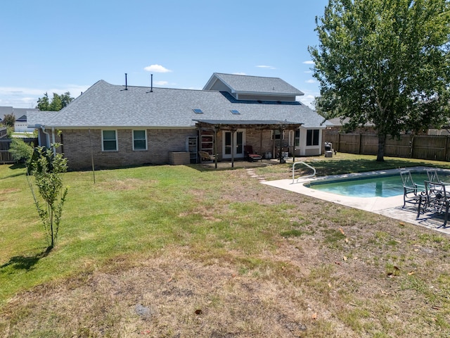 view of swimming pool featuring a lawn and a patio area