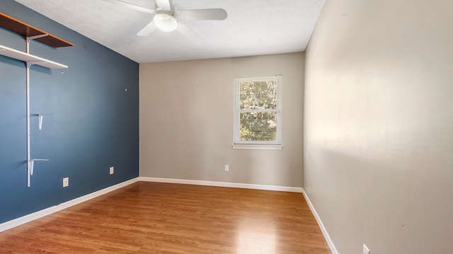 empty room featuring hardwood / wood-style floors, ceiling fan, and a textured ceiling