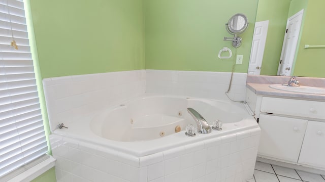 bathroom with tiled tub, vanity, and tile patterned floors