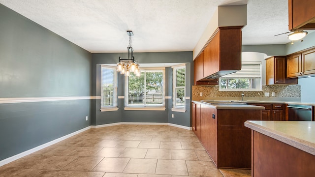 kitchen featuring a notable chandelier, light tile patterned flooring, pendant lighting, tasteful backsplash, and stainless steel dishwasher