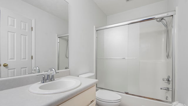 full bathroom featuring vanity, toilet, and enclosed tub / shower combo