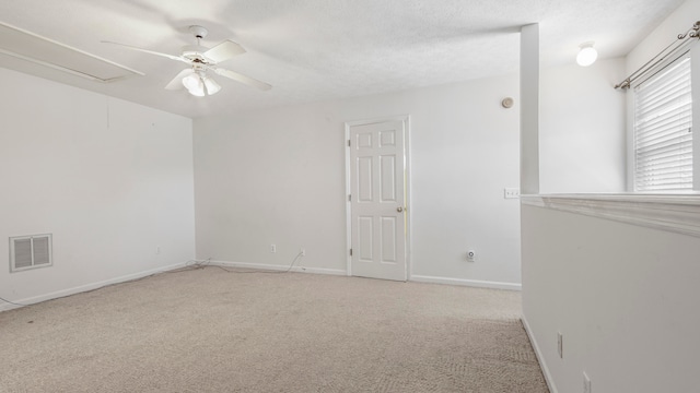 carpeted empty room featuring a textured ceiling and ceiling fan