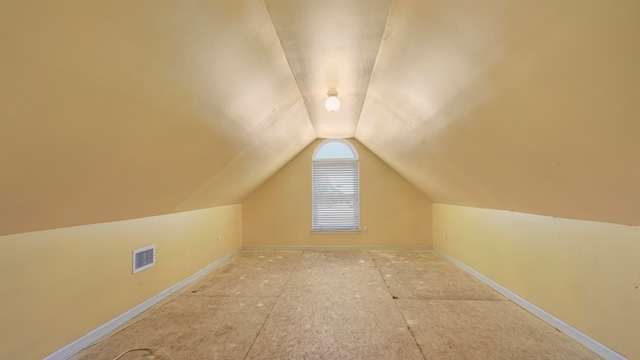 additional living space featuring lofted ceiling