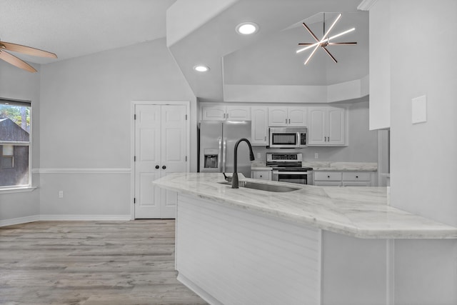 kitchen with white cabinets, light wood-type flooring, appliances with stainless steel finishes, sink, and ceiling fan