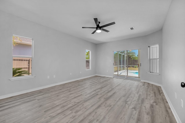 empty room with light hardwood / wood-style flooring and ceiling fan