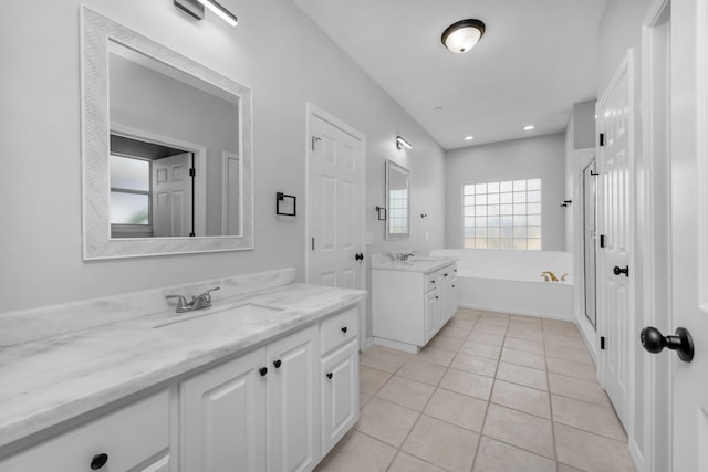 bathroom with tile patterned flooring, vanity, and shower with separate bathtub