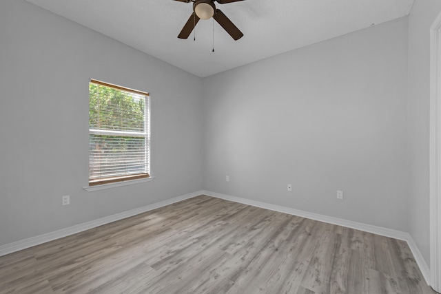 spare room featuring light hardwood / wood-style flooring and ceiling fan