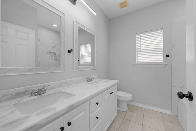 bathroom featuring tile patterned floors, tiled shower, toilet, and vanity