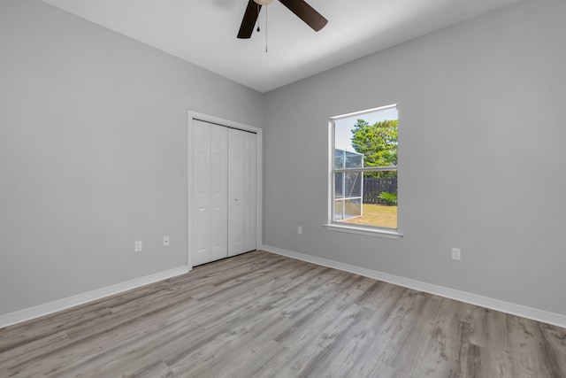 unfurnished bedroom with a closet, ceiling fan, and light hardwood / wood-style floors