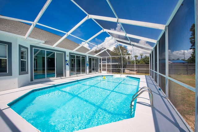 view of pool featuring a patio and glass enclosure