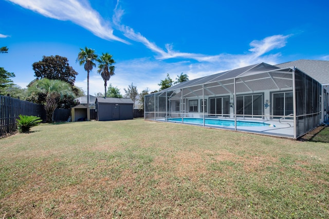 view of yard featuring a fenced in pool, a lanai, and a storage shed