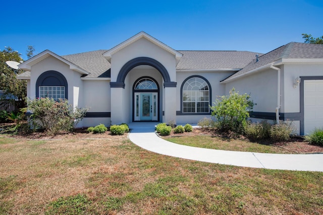 single story home with a front yard and a garage