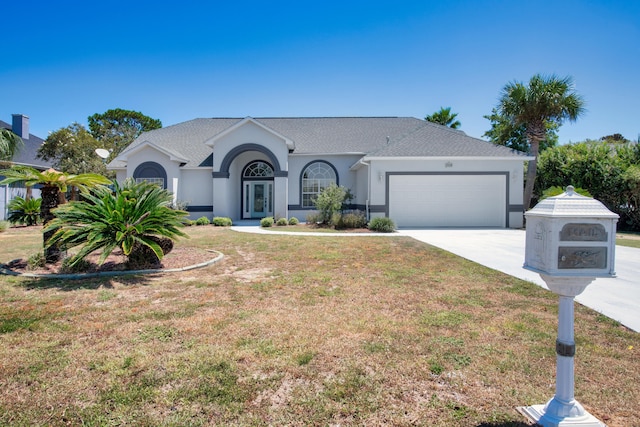 single story home featuring a garage and a front yard