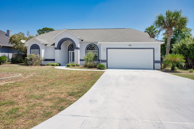 ranch-style home with a garage and a front lawn