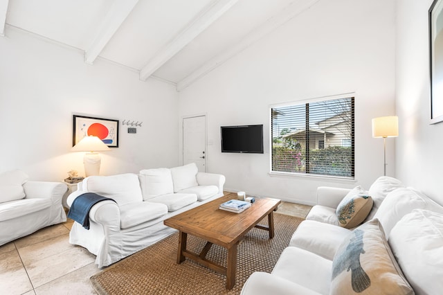 living room with vaulted ceiling with beams and light tile patterned flooring