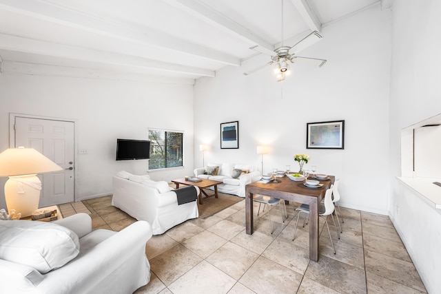 living room featuring ceiling fan, light tile patterned floors, and beamed ceiling