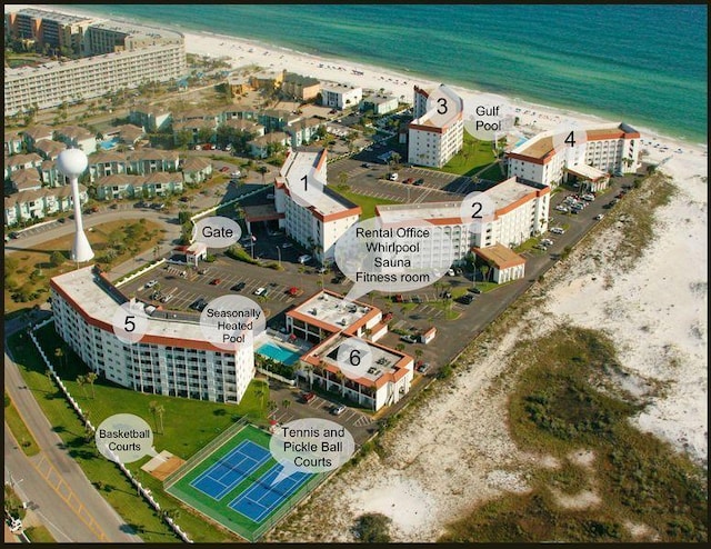 birds eye view of property featuring a water view, a view of city, and a beach view