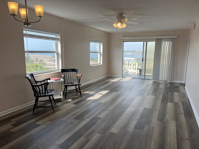 unfurnished room with dark wood-style floors, plenty of natural light, baseboards, and a ceiling fan