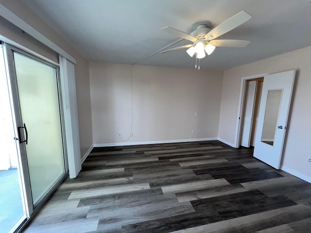 empty room with ceiling fan, baseboards, and wood finished floors