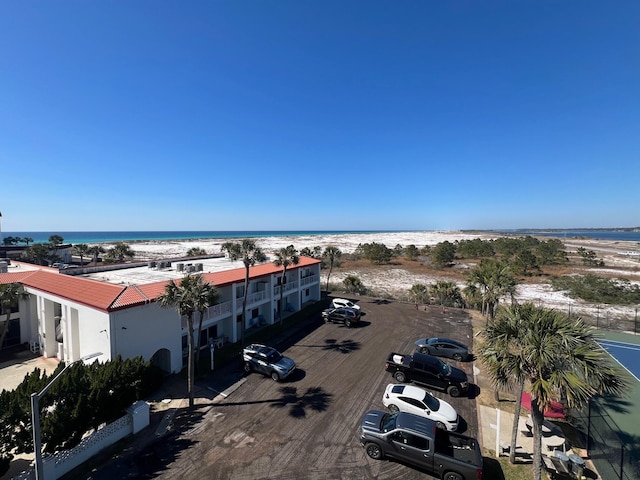 birds eye view of property featuring a view of the beach and a water view