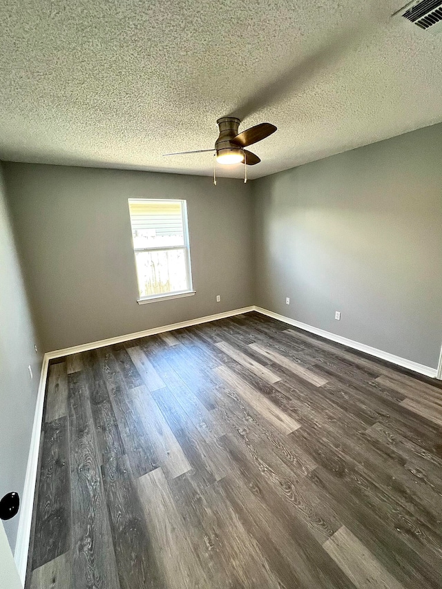 unfurnished room featuring ceiling fan, dark hardwood / wood-style floors, and a textured ceiling