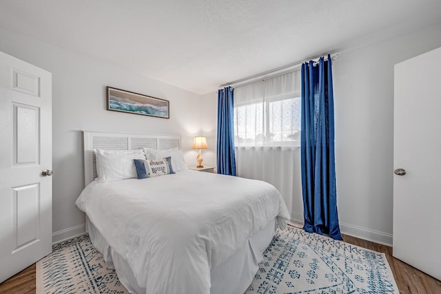 bedroom with hardwood / wood-style flooring