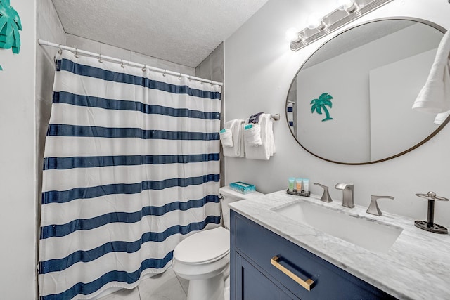 bathroom with a textured ceiling, vanity, curtained shower, toilet, and tile patterned floors