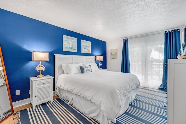 bedroom featuring a textured ceiling and wood-type flooring