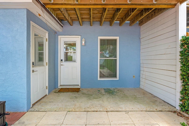 entrance to property with a patio